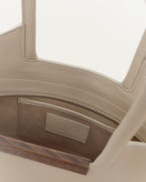 Interior view of small garden tote bag in cream showing soft leather and walnut wood detailing.