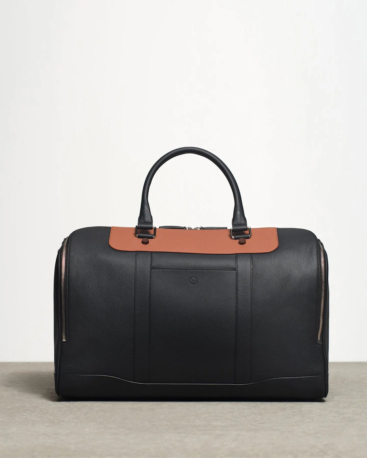 leather cooper's duffle bag In black and tan side view