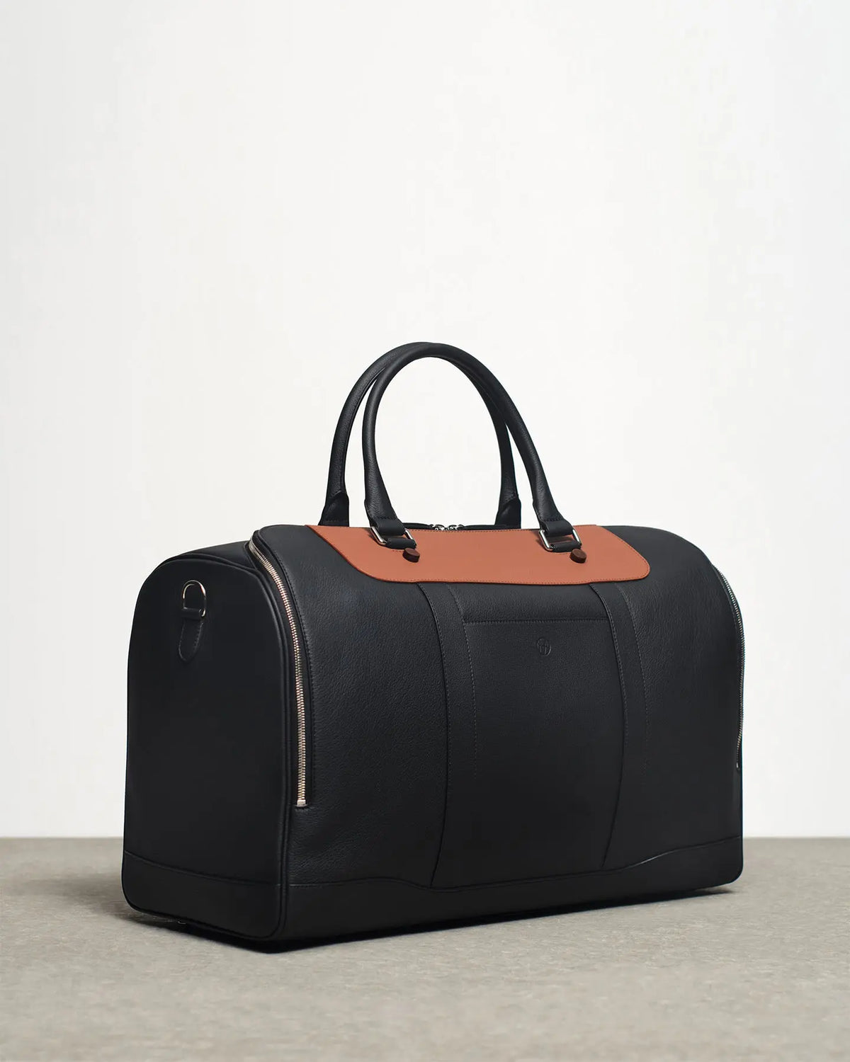 cooper's duffle bag in black and tan side view