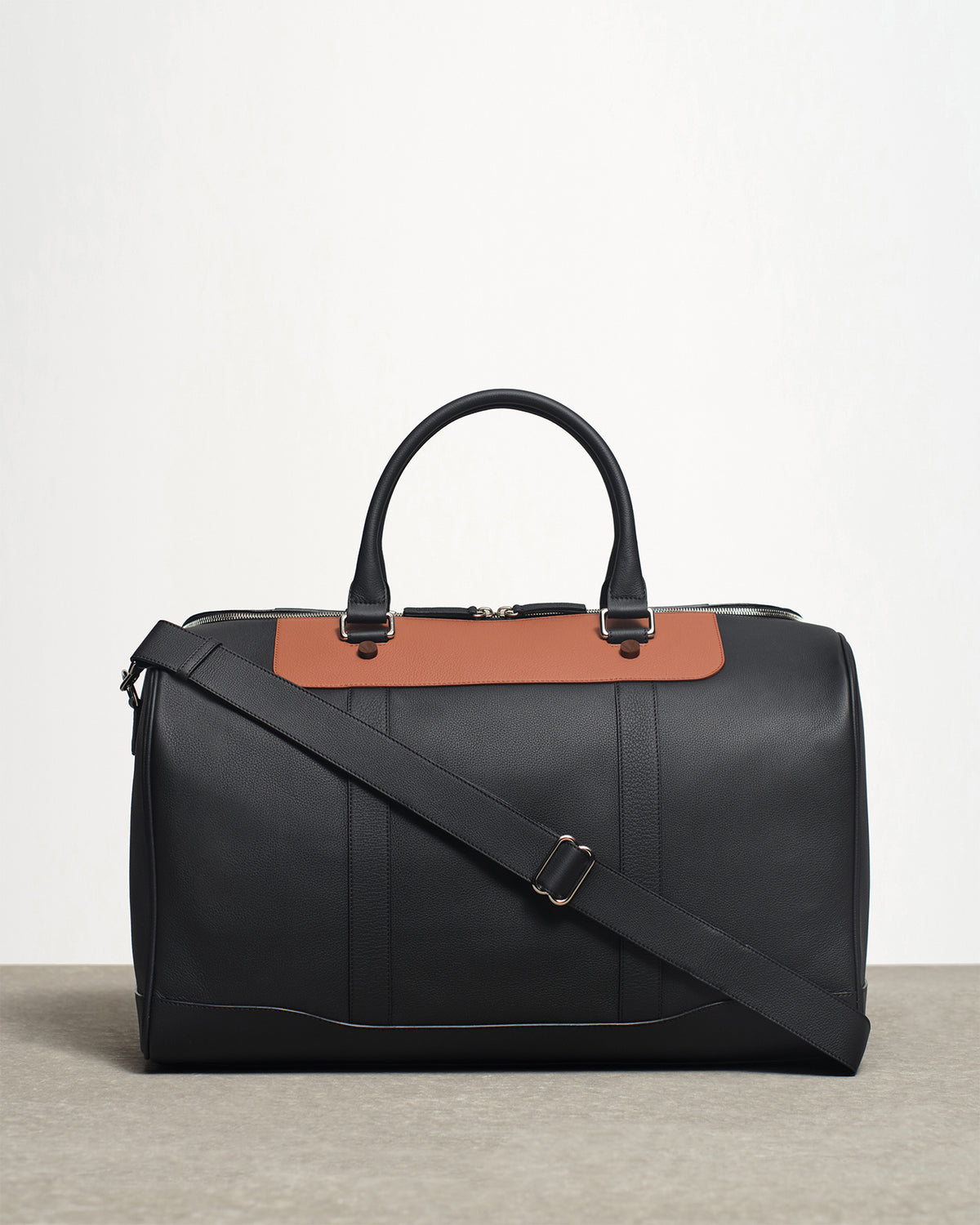 cooper's duffle bag in black and tan front view