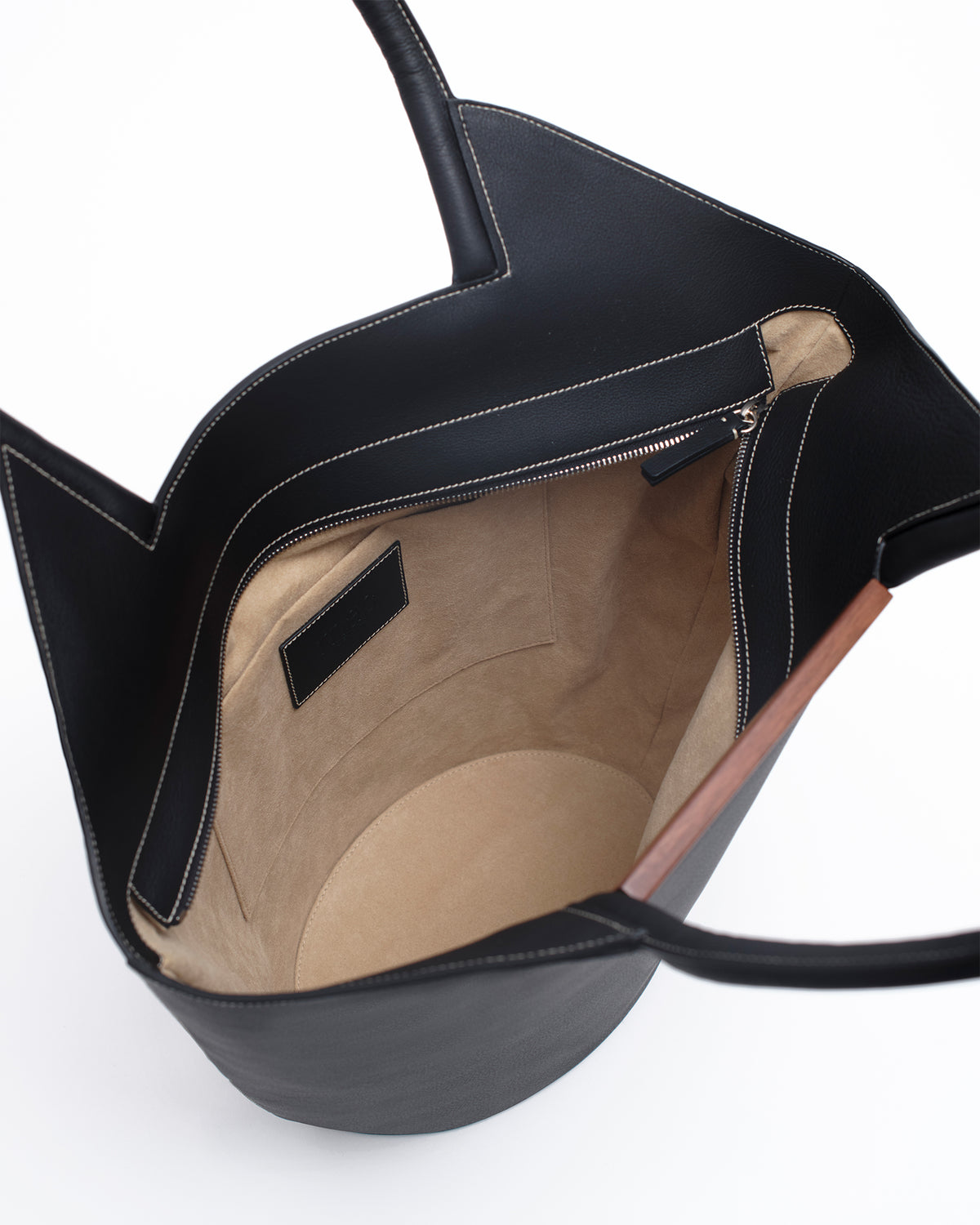 Garden Tote bag in black - contrast stitch featuring grained taurillon leather and walnut wood bar detail.
