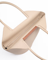 Garden tote bag in beige featuring grained taurillon leather and walnut wood bar detail.
