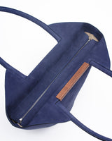 Garden tote bag in dark blue featuring grained taurillon leather and walnut wood bar detail.