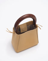 small structured leather quinta bag in amber walnut handle detail