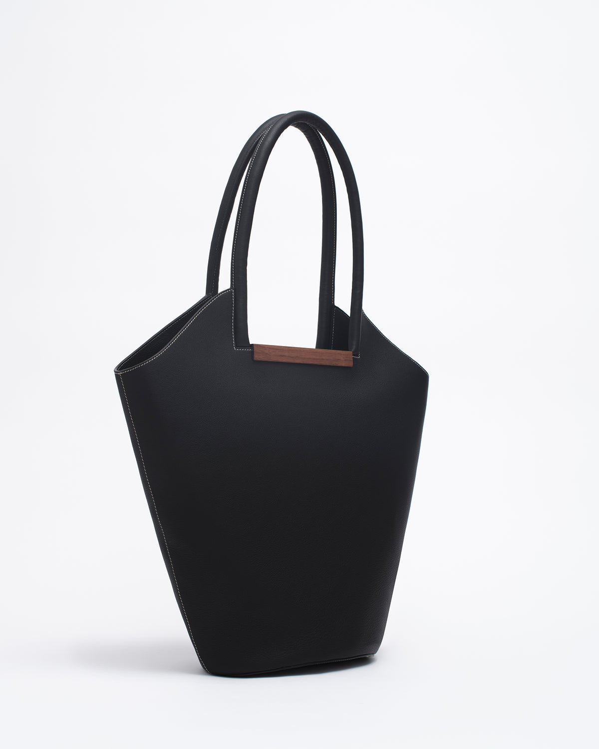Garden Tote bag in black - contrast stitch  with wooden crafted handle, showcasing a sculptural design and soft suede texture.