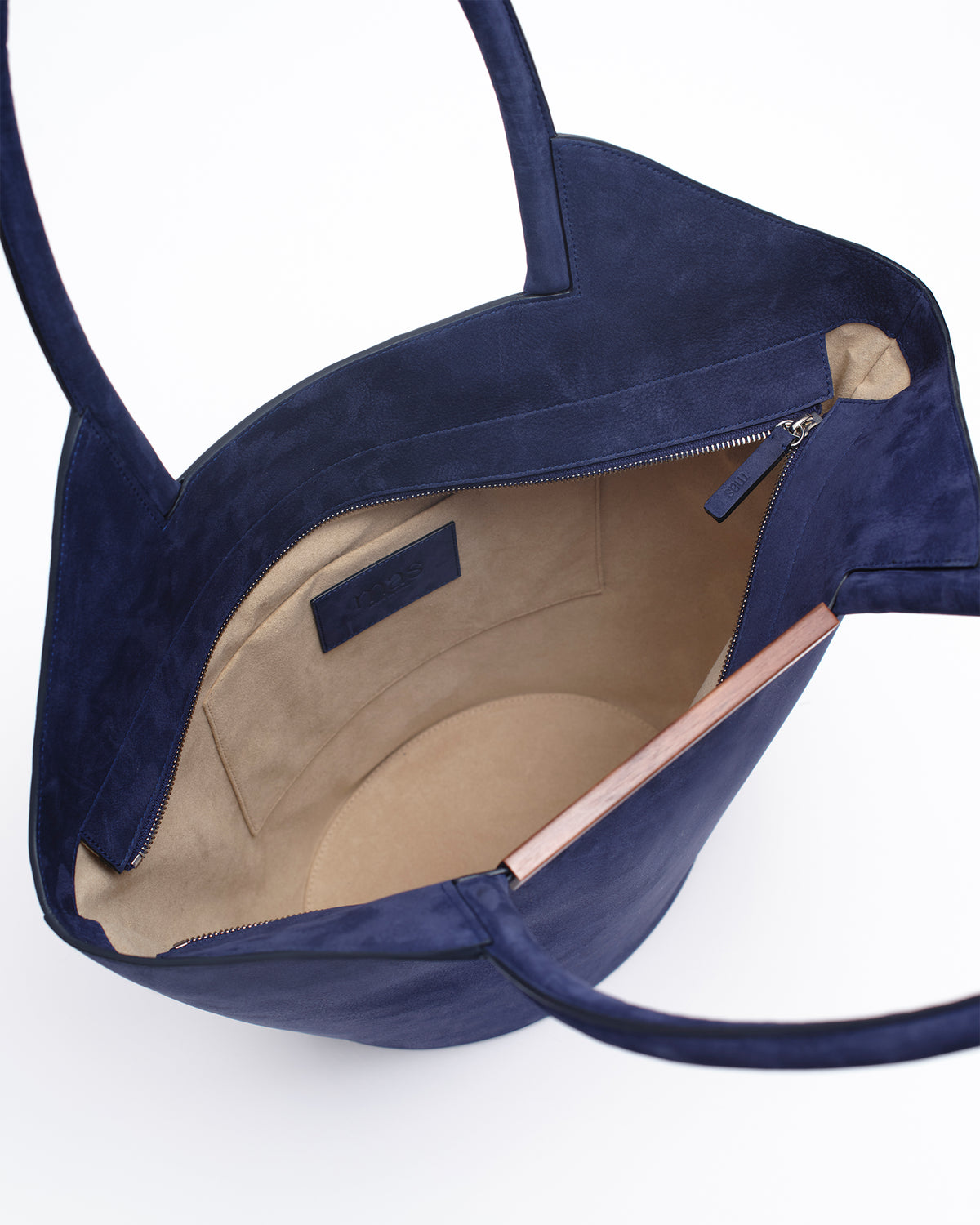 Interior view of a garden tote bag in dark blue with a soft lining and zip closure.